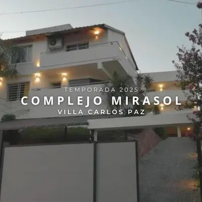 a sign in front of a building at Complejo Mirasol en Carlos Paz in Villa Carlos Paz
