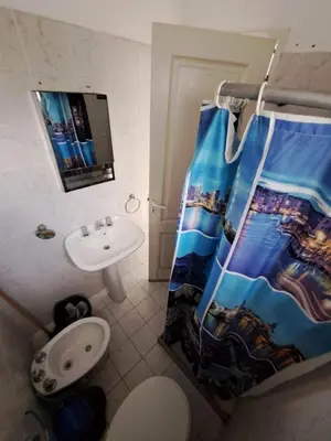 a bathroom with a shower curtain and a sink at Duplex en complejo in Villa Carlos Paz