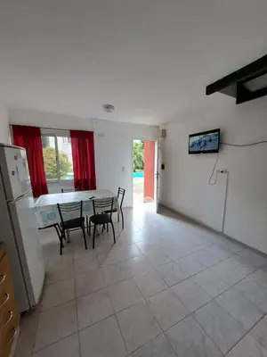 a kitchen and dining room with a table and chairs at Duplex en complejo in Villa Carlos Paz