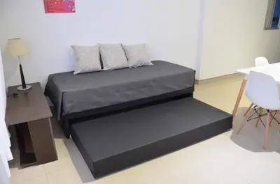 a bed with two pillows on it in a room at Amplio departamento de un dormitorio a 15 min del centro de la ciudad in Cordoba