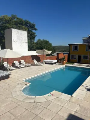 a large swimming pool with chairs and umbrellas at A carlos paz voy in Villa Carlos Paz