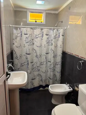 a bathroom with a sink and a shower curtain at A carlos paz voy in Villa Carlos Paz