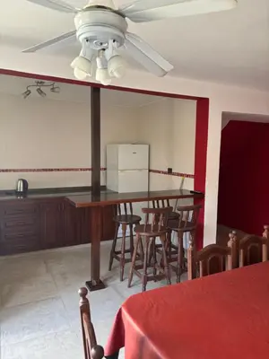 a dining room with a table and chairs and a ceiling fan at A carlos paz voy in Villa Carlos Paz