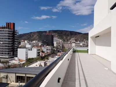 a view of a city from the balcony of a building at Centro Carlos Paz Cibeles in Villa Carlos Paz