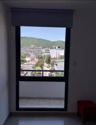 a window in a room with a view of a city at Centro Carlos Paz Cibeles in Villa Carlos Paz