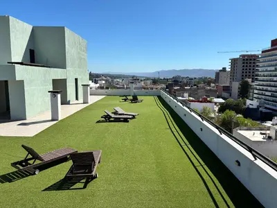 a green roof with benches on top of a building at Centro Carlos Paz Cibeles in Villa Carlos Paz