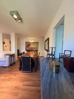 a living room with a table and chairs and a bed at Departamento Córdoba IV, estadio Kempes, Siglo 21,Cerro de las Rosas, Chateau in Cordoba