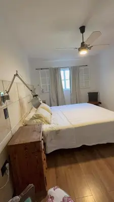 a bedroom with a large bed and a lamp at Departamento Córdoba IV, estadio Kempes, Siglo 21,Cerro de las Rosas, Chateau in Cordoba