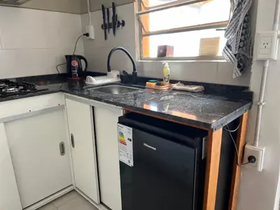 a kitchen with a sink and a black dishwasher at La Petrona in Alta Gracia