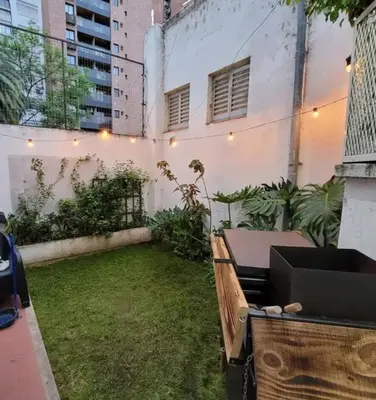 a small backyard with a table and a lawn at Departamento en Cordoba in Cordoba
