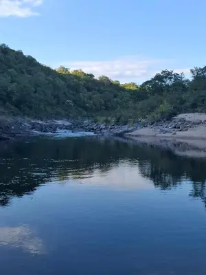 a body of water with trees in the background at Casa Ortiz in Villa Canada del Sauce