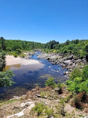 a river in the middle of a field at Casa Ortiz in Villa Canada del Sauce