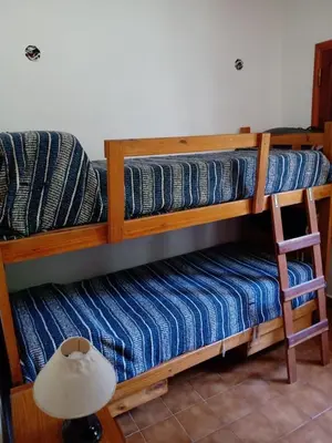 two bunk beds in a room with a lamp at Casa Ortiz in Villa Canada del Sauce