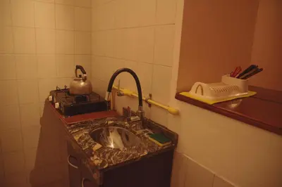 a kitchen counter with a sink and a tea kettle at Departamento en Embalse in Embalse