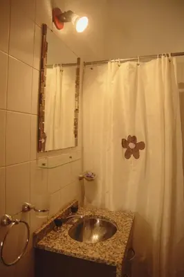 a bathroom with a sink and a shower curtain at Departamento en Embalse in Embalse