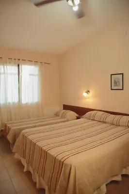 a bedroom with two beds and a window at Departamento en Embalse in Embalse