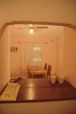 a dining room with a table and a table and chairs at Departamento en Embalse in Embalse