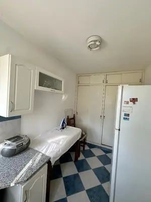 a kitchen with a refrigerator and a checkered floor at El GOLF in Alta Gracia