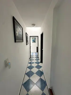a hallway with a black and white checkered floor at El GOLF in Alta Gracia