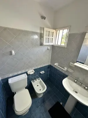 a bathroom with a toilet and a sink at El GOLF in Alta Gracia