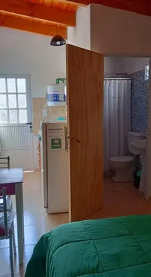 a room with a bathroom with a toilet and a refrigerator at Rincón de las Calandrias Embalse in Embalse