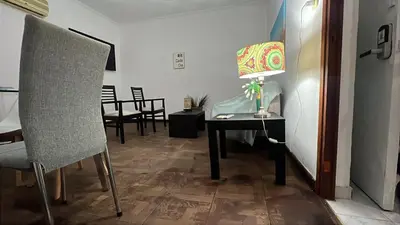 a room with a table with a lamp and a chair at CENTRO CORDOBA departamento 2 dormitorios in Cordoba