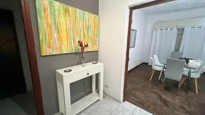 a living room with a fireplace and a painting on the wall at CENTRO CORDOBA departamento 2 dormitorios in Cordoba