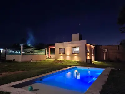 a house with a swimming pool at night at Complejo San roque in San Roque