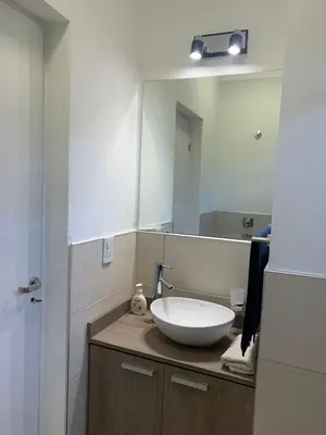 a bathroom with a sink and a large mirror at Complejo San roque in San Roque