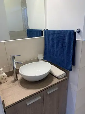 a bathroom with a white bowl sink on a counter at Complejo San roque in San Roque