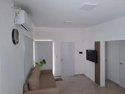 a living room with a couch and a tv at Complejo San roque in San Roque