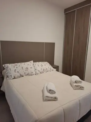 a bedroom with a bed with towels on it at Complejo San roque in San Roque