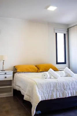 a bedroom with a bed with towels on it at El Nuevo Obispo, ubicación 5 estrellas, balcón y pileta in Cordoba