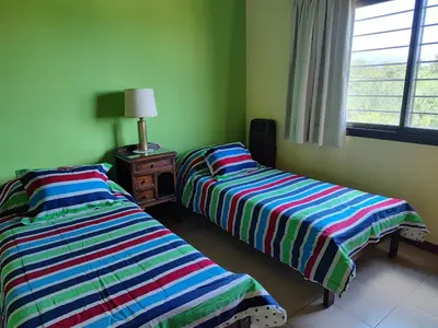 two beds sitting next to each other in a room at La Aurora in Merlo