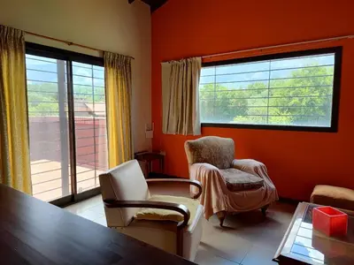a living room with two chairs and a table at La Aurora in Merlo