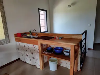a kitchen with a wooden counter with a sink at La Aurora in Merlo