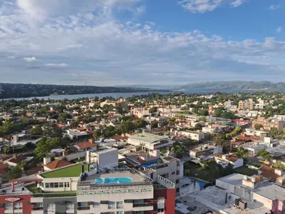 an aerial view of a city with a body of water at Departamento Miralejos 16 in Villa Carlos Paz