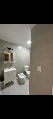 a bathroom with a sink and a toilet and a sink at Departamento Miralejos 16 in Villa Carlos Paz
