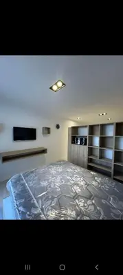 a bedroom with a large bed in a room at Departamento Miralejos 16 in Villa Carlos Paz