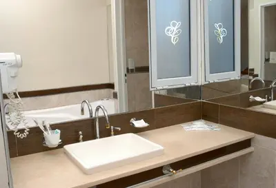 a bathroom with a sink and a mirror at Santa Cecilia Resort & Spa I in Villa Carlos Paz