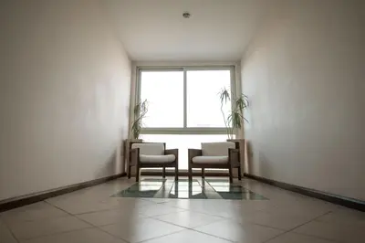a room with a table and chairs and a window at Santa Cecilia Resort & Spa I in Villa Carlos Paz