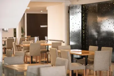 a dining room with wooden tables and chairs at Santa Cecilia Resort & Spa I in Villa Carlos Paz