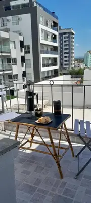 a picnic table on top of a balcony at Mis 4 estaciones in Villa Carlos Paz