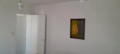 a painting on a white wall next to a door at Mis 4 estaciones in Villa Carlos Paz