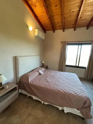 a bedroom with a bed in a room with a window at Refugio de las Nubes in Las Rabonas