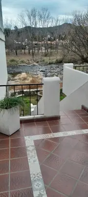 a balcony with a view of a river at Complejo Pichona - Villa Carlos Paz - San Antonio in San Antonio de Arredondo