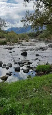 a river with some rocks in the water at Complejo Pichona - Villa Carlos Paz - San Antonio in San Antonio de Arredondo
