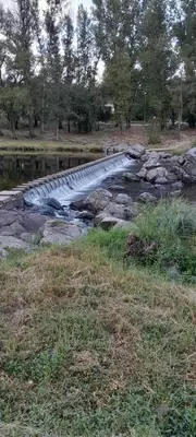 a bridge over a river in a field at Complejo Pichona - Villa Carlos Paz - San Antonio in San Antonio de Arredondo