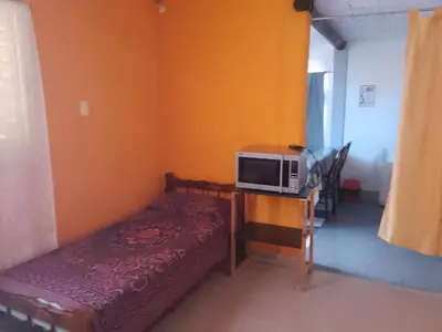 a small room with a microwave on a table at Dpto Bordo in Villa Cura Brochero