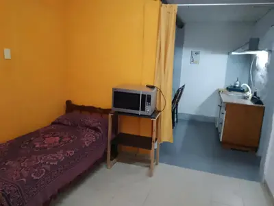 a small bedroom with a bed and a sink at Dpto Bordo in Villa Cura Brochero